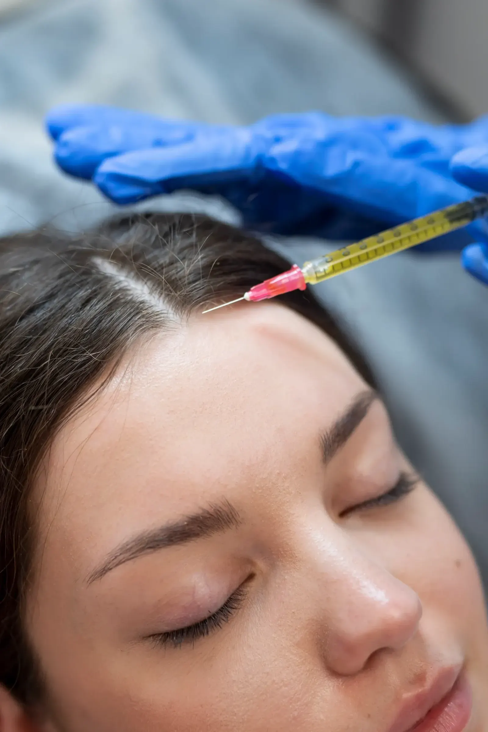 Provider reviewing PRP hair treatment safety information with a patient at Pura Vida Med Spa