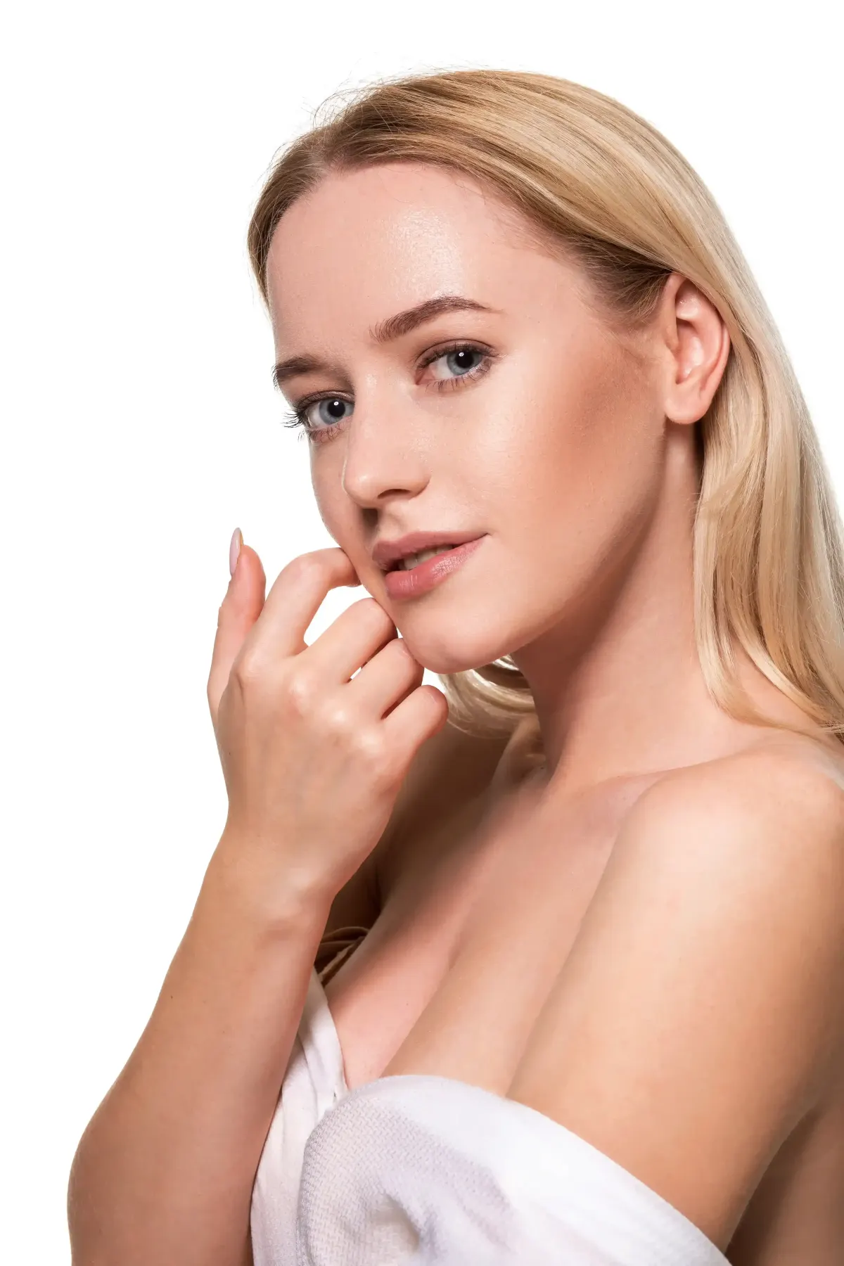 Woman with smooth, radiant skin gently touching her face
