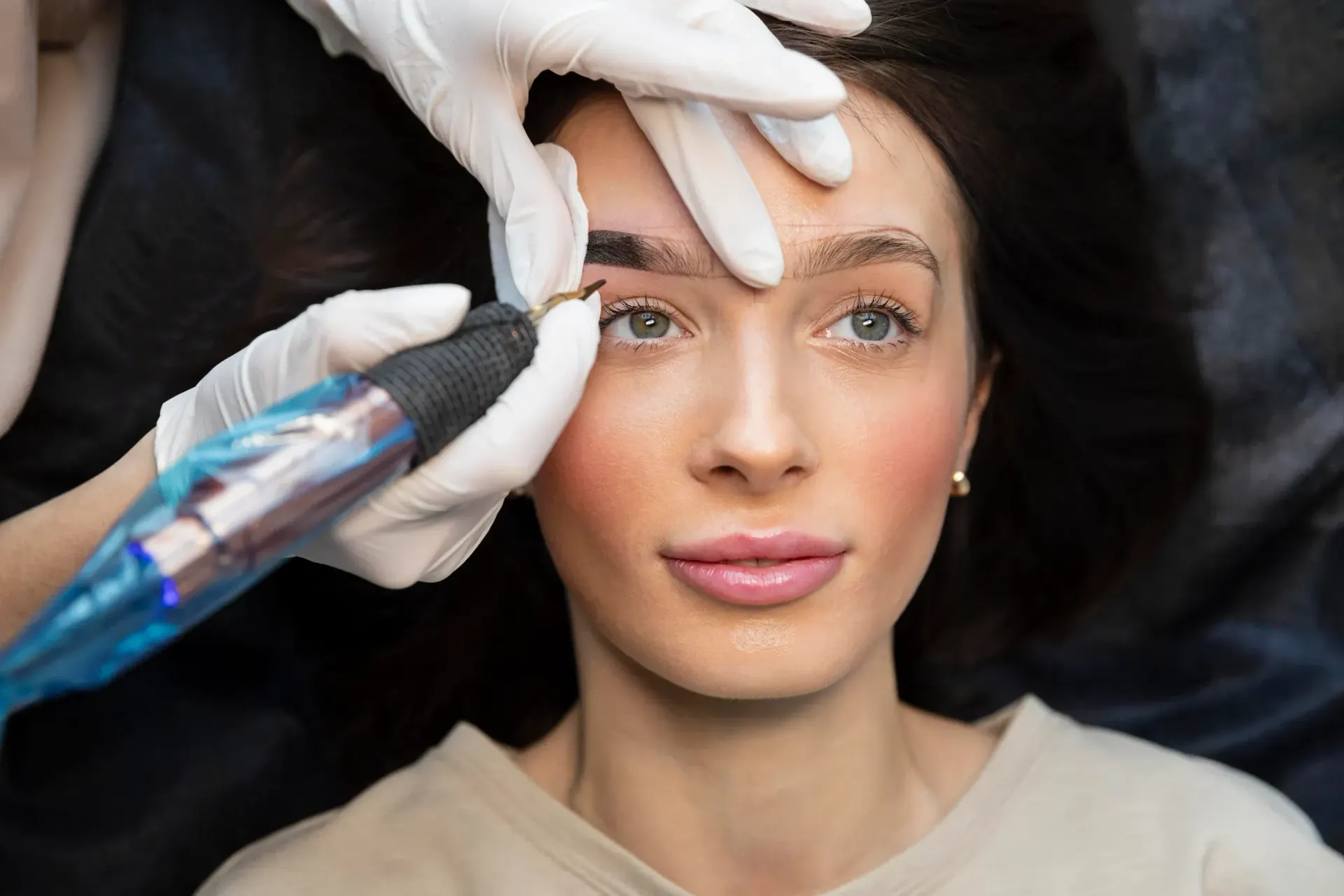 Close-up of a woman's softly blushed lips and defined eyeliner after a permanent makeup session at Pura Vida Med Spa in Fulton, MD