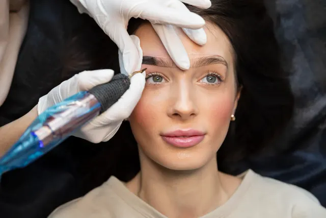 Close-up of a woman's softly blushed lips and defined eyeliner after a permanent makeup session at Pura Vida Med Spa in Fulton, MD
